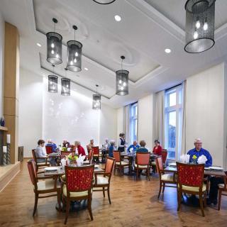 A group of people dining in a well-lit restaurant with modern decor.