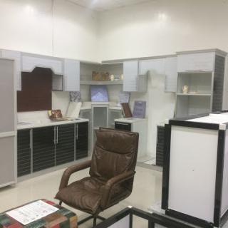 A modern office workspace featuring sleek storage cabinets and a comfortable brown chair.