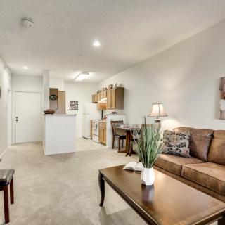 A modern open-concept living room with a view into the kitchen area.