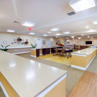 A modern and spacious kitchen interior with ample countertops and a seating area.