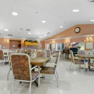 An indoor dining area with tables and chairs arranged neatly.