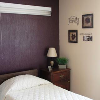 A cozy and stylish bedroom featuring a warm color palette, tasteful decor, and a comfortable bed.
