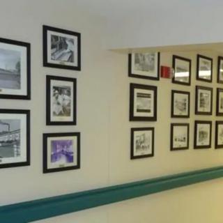 A hallway adorned with a collection of framed photographs and artwork.