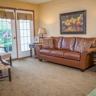 A cozy living room with a brown leather sofa and stylish decor.