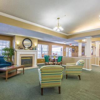 A cozy living room with comfortable seating, a fireplace, and large windows.