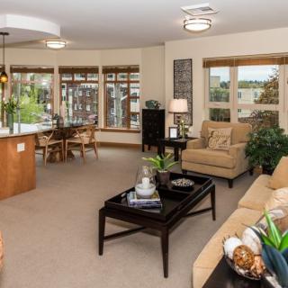 A modern and well-decorated living room with ample natural light.