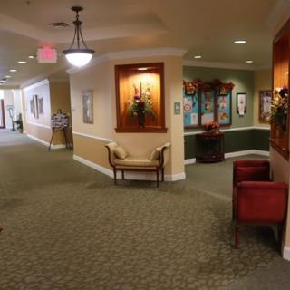 A well-lit hallway with seating and decorative elements.