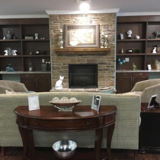 A cozy living room setup featuring a stone fireplace and stylish decor.