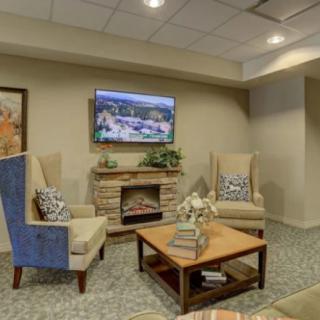 A cozy living room with comfortable seating, a television, and elegant decor.