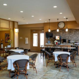A cozy dining area with neatly arranged tables and a bar counter.