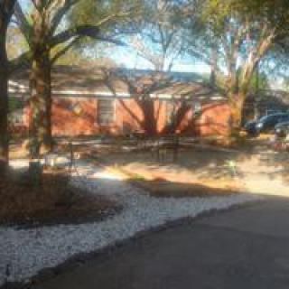 A suburban house with a landscaped front yard and driveway.