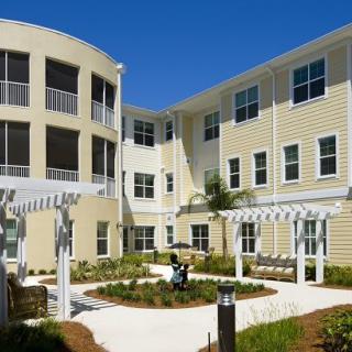 A modern apartment building with a landscaped courtyard.