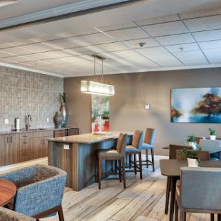 A modern lounge area featuring a kitchenette and dining space, designed for comfort and social interaction.