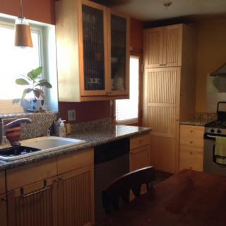 A cozy kitchen with wooden cabinets and modern appliances.