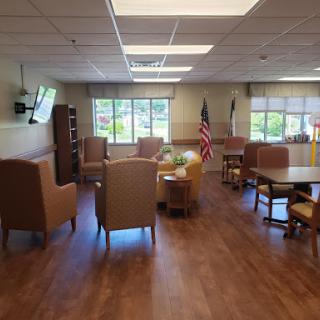 A cozy lounge area featuring comfortable seating, natural light from the windows, and a welcoming atmosphere.