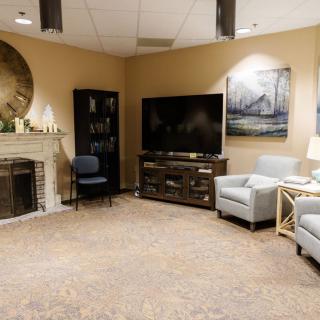 A cozy living room with a fireplace, television, and comfortable seating.