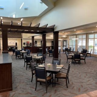 A spacious and modern dining area with tables and chairs arranged for guests.