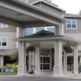 A building entrance with a covered portico leading to the main doors.