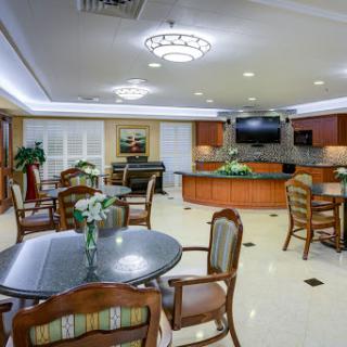 A cozy and inviting common area featuring comfortable seating and dining options.