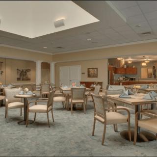 A well-lit dining area with neatly arranged tables and chairs.