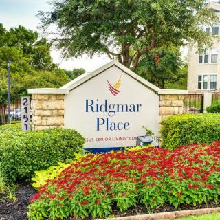 Entrance sign for Ridgmar Place, surrounded by well-maintained landscaping.