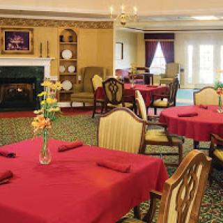 An elegant dining room featuring red tablecloths and comfortable seating, perfect for a cozy meal.