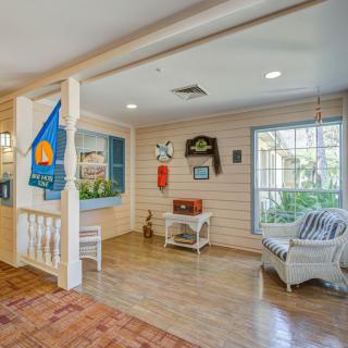 A cozy living space featuring wooden floors, comfortable seating, and homey decor.