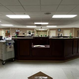 View of a hospital nurse station with medical equipment and reception area.