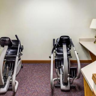 A small fitness room featuring two stationary exercise bikes.