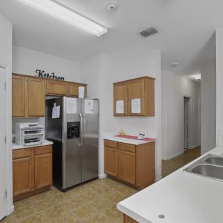 Modern kitchen with wooden cabinets and stainless steel appliances.