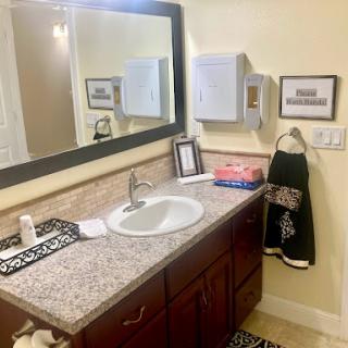 A neatly organized bathroom with a stylish vanity and modern fixtures.