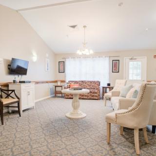 A cozy living room with comfortable seating, a TV, and elegant decor.