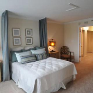 A cozy, modern bedroom with a neatly made bed and stylish decor.
