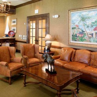 A cozy living room featuring leather furniture and elegant decor.