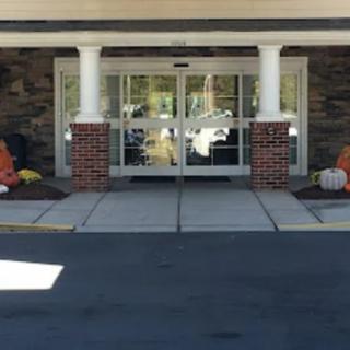 Entrance of a building decorated with pumpkins for autumn.