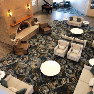 Spacious hotel lobby with stylish seating and decor.