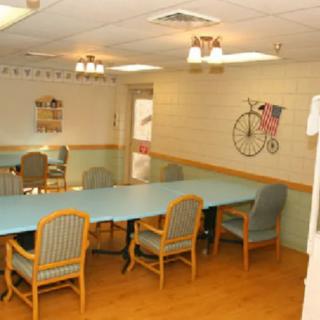 A well-lit conference room with a long table surrounded by chairs, featuring bicycle-themed wall art.