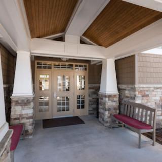 Building entrance with stone walls and benches.