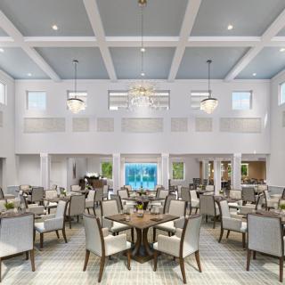 A spacious and elegantly designed dining hall featuring modern decor with tables, chairs, chandeliers, and a high ceiling.