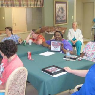 A group of people gathered around a table for a meeting.