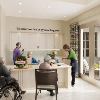 A group of seniors engaging in a social activity in a modern kitchen setting.