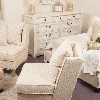 A cozy living room with cream-colored furniture and elegant decor.