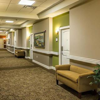 A well-lit hallway with carpeted flooring and comfortable seating.