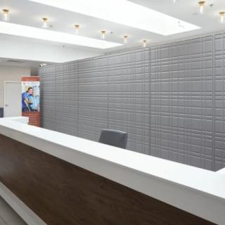 A modern reception desk in a well-lit office with a sleek design.