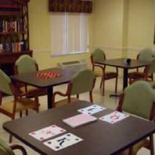 A game room with tables set for card and board games.
