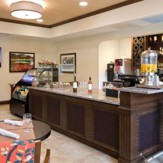 A cozy cafe setup with a self-service beverage station and snacks.