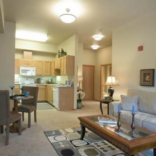 A cozy apartment interior featuring an open living room and kitchen layout.