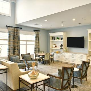 A modern living room with comfortable seating, a large television, and elegant decor.