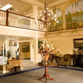 Elegant hotel lobby with a chandelier and decorative artwork.
