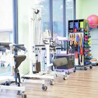 A well-equipped physical therapy room featuring various rehabilitation and exercise equipment.